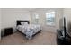 Bedroom with carpet, two windows, a queen bed, and a nightstand at 3508 Brighton Park Cir, Belle Isle, FL 32812