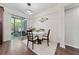 Bright dining area with modern lighting fixture, sliding glass doors, and access to outdoor patio at 3508 Brighton Park Cir, Belle Isle, FL 32812