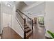 Entryway with hardwood floors, staircase, and open view to the kitchen and dining area at 3508 Brighton Park Cir, Belle Isle, FL 32812