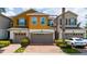Two-story townhouse featuring an attached garage and well-maintained landscaping at 3508 Brighton Park Cir, Belle Isle, FL 32812