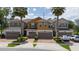 Charming townhome showcasing a neutral color palette, a 2-car garage and palm trees at 3508 Brighton Park Cir, Belle Isle, FL 32812