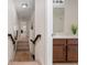 Hallway leading to the bathroom with wooden handrail and stair treads at 3508 Brighton Park Cir, Belle Isle, FL 32812
