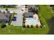 Aerial shot of a community pool area with lounge chairs next to a pond at 3508 Brighton Park Cir, Belle Isle, FL 32812