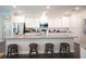 Kitchen featuring stainless steel appliances, white cabinets, and granite countertops with barstool seating at 351 S Sunset Ave, Mascotte, FL 34753