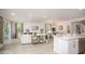 Bright, open living space with kitchen island, sliding glass doors, hardwood floors, and modern decor at 351 S Sunset Ave, Mascotte, FL 34753