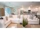 Living room featuring a large sofa that opens into a modern kitchen and breakfast area at 351 S Sunset Ave, Mascotte, FL 34753