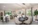 Bright and airy living room with a dining table and modern chandelier, showcasing an open-concept design at 351 S Sunset Ave, Mascotte, FL 34753