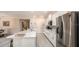 Open floor plan featuring a living area that leads to a kitchen with stainless steel appliances at 351 S Sunset Ave, Mascotte, FL 34753
