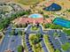 Stunning aerial view of the community clubhouse, pool, tennis courts, and surrounding landscaped grounds at 3574 La Jolla Dr, Clermont, FL 34711