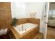 Bathroom with a soaking tub set in tile with a window that has plantation shutters at 3574 La Jolla Dr, Clermont, FL 34711
