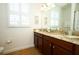 Bright bathroom features double sinks, granite countertops, and plantation shutters at 3574 La Jolla Dr, Clermont, FL 34711