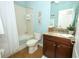 Bathroom featuring blue accents, a shower and bathtub, and a granite vanity at 3574 La Jolla Dr, Clermont, FL 34711