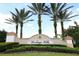 Elegant community sign for Heritage Hills, framed by lush greenery and palm trees, welcoming residents and visitors at 3574 La Jolla Dr, Clermont, FL 34711