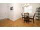Cozy dining area with brown tile flooring, a round table and stylish decor at 3574 La Jolla Dr, Clermont, FL 34711