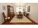Formal dining room featuring wood flooring, a chandelier and large window at 3574 La Jolla Dr, Clermont, FL 34711