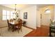 Formal dining room with elegant chandelier and a door to the foyer at 3574 La Jolla Dr, Clermont, FL 34711