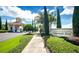 Community entrance featuring a gatehouse, lush landscaping, and the Heritage Hills sign at 3574 La Jolla Dr, Clermont, FL 34711