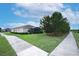 A well-maintained single-Gathering home with manicured lawn, tasteful landscaping, and a screened in lanai in the backyard at 3574 La Jolla Dr, Clermont, FL 34711