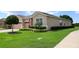Charming single-story home with manicured lawn, trimmed hedges, and a two-car garage, exuding curb appeal at 3574 La Jolla Dr, Clermont, FL 34711