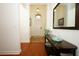 Inviting foyer with wood flooring, decorative table and mirror at 3574 La Jolla Dr, Clermont, FL 34711
