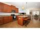 Open kitchen with granite countertops, stainless steel appliances, and a center island with barstool seating at 3574 La Jolla Dr, Clermont, FL 34711