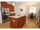 Well-lit kitchen with granite island, stainless appliances, and adjacent dining area for easy entertaining at 3574 La Jolla Dr, Clermont, FL 34711