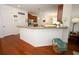 Kitchen with granite countertops, wood cabinets, stainless steel appliances, and breakfast bar at 3574 La Jolla Dr, Clermont, FL 34711