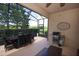 Spacious screened-in lanai with outdoor dining, BBQ grill, and serene views of the surrounding landscape at 3574 La Jolla Dr, Clermont, FL 34711