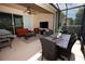 Relax on this spacious, screened lanai featuring comfortable seating, outdoor dining, and a BBQ grill at 3574 La Jolla Dr, Clermont, FL 34711