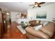 Comfortable living room featuring hardwood floors, neutral decor, and access to the kitchen at 3574 La Jolla Dr, Clermont, FL 34711