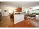 Open-concept living space featuring wood floors, eat in kitchen, and access to the lanai at 3574 La Jolla Dr, Clermont, FL 34711