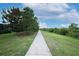 Scenic walking path alongside lush greenery, providing a serene environment for outdoor activities at 3574 La Jolla Dr, Clermont, FL 34711