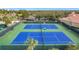Two beautifully maintained tennis courts with green and blue playing surfaces at 3574 La Jolla Dr, Clermont, FL 34711