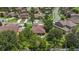 Aerial view of a home showcasing the backyard, mature trees, and surrounding neighborhood at 3637 Foxchase Dr, Clermont, FL 34711