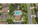An aerial view of community pool, playground, clubhouse, parking lot, and walking paths at 3637 Foxchase Dr, Clermont, FL 34711
