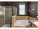 Bathroom featuring a tiled shower, soaking tub and window for natural light, perfect for relaxation at 3637 Foxchase Dr, Clermont, FL 34711