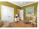 Bright bedroom with hardwood floors and decorated with colorful artwork and white trim for a lively touch at 3637 Foxchase Dr, Clermont, FL 34711
