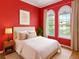 Cozy bedroom with natural light from large windows, complete with neutral bedding and bedside table at 3637 Foxchase Dr, Clermont, FL 34711