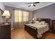 Comfortable bedroom with a ceiling fan, large window, and elegant decor at 3637 Foxchase Dr, Clermont, FL 34711