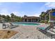 Community pool area featuring shaded pergola, brick-paved patio and a range of sun loungers for relaxation and recreation at 3637 Foxchase Dr, Clermont, FL 34711