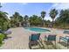 Community pool with a brick-paved patio and sun loungers, creating a resort-like atmosphere for relaxation and recreation at 3637 Foxchase Dr, Clermont, FL 34711