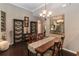 Inviting dining room featuring hardwood floors, decorative shelving, and an elegant chandelier at 3637 Foxchase Dr, Clermont, FL 34711