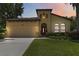 Charming home featuring a well-manicured lawn, two-car garage, and a unique architectural design at 3637 Foxchase Dr, Clermont, FL 34711