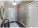 Bright foyer featuring hardwood floors, neutral paint, and an ornate mirror at 3637 Foxchase Dr, Clermont, FL 34711