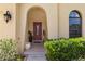 Inviting front entrance with a decorative door and lush landscaping at 3637 Foxchase Dr, Clermont, FL 34711