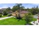 Charming single-story home featuring lush landscaping, a well-manicured lawn, and a classic stucco facade at 3637 Foxchase Dr, Clermont, FL 34711