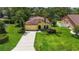 Charming single-Gathering home with a well-maintained lawn and mature landscaping, including palm trees at 3637 Foxchase Dr, Clermont, FL 34711