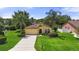 Charming single-story home featuring lush landscaping, a well-manicured lawn, and a classic stucco facade at 3637 Foxchase Dr, Clermont, FL 34711