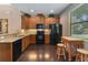Bright kitchen with granite countertops, wooden cabinets, and view of the backyard at 3637 Foxchase Dr, Clermont, FL 34711