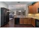 Open kitchen featuring granite countertops, wooden cabinets, and seamless flow to the living area at 3637 Foxchase Dr, Clermont, FL 34711